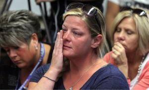 In this Friday, Oct. 3, 2014 photograph, audience members react as members of the Sayreville Board of Education hold a press conference at the Selover School in South Amboy, N.J., to address a hazing incident that "went too far" and is at the center of the investigation into the Sayreville War Memorial High School football team. On Monday, Oct. 6, 2014 school superintendent Richard Labbe said the Sayreville War Memorial High School football season has been canceled amid allegations of harassment, intimidation and bullying among players. (APPhoto/ Home News Tribune, Mark R. Sullivan) On Friday October 3,,2014 Photo: Mark R. Sullivan/Home News Tribune/AP